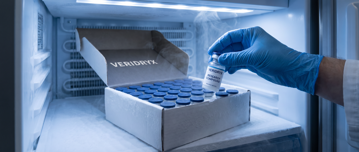 Gloved hand taking a Veridryx research vial from a cryo box in a laboratory freezer